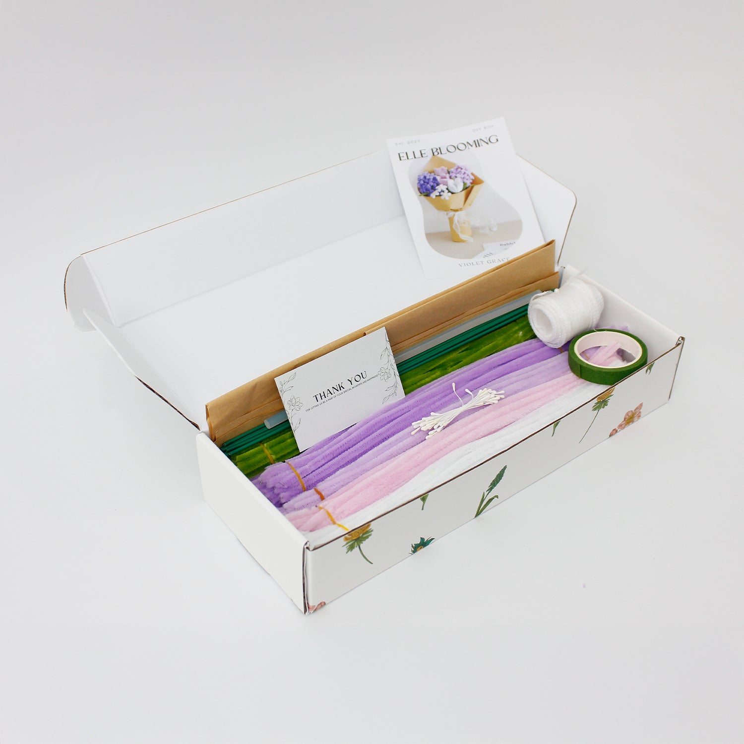 Violet Grace DIY bouquet featuring handcrafted lilac and purple hyacinths, pink and white tulips, and dainty white blossoms made from pipe cleaners. Wrapped in kraft paper with a soft white ribbon, perfect for elegant handmade gifts.