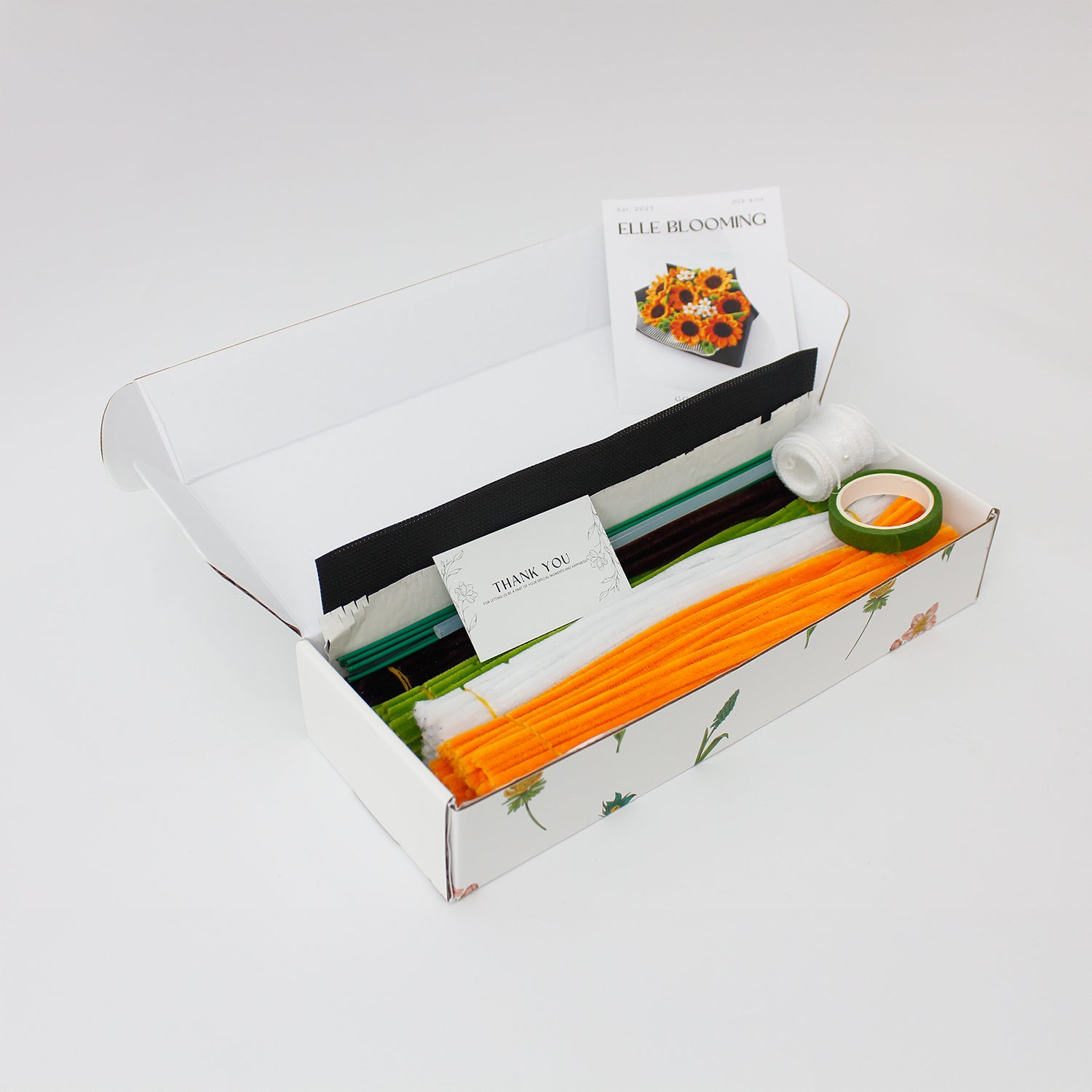 Golden Hour DIY sunflower bouquet made from vibrant orange pipe cleaners, featuring handmade daisies and lush green stems. Wrapped in black mesh and paper for a bold, elegant contrast ideal for DIY lovers and heartfelt handmade gifts.