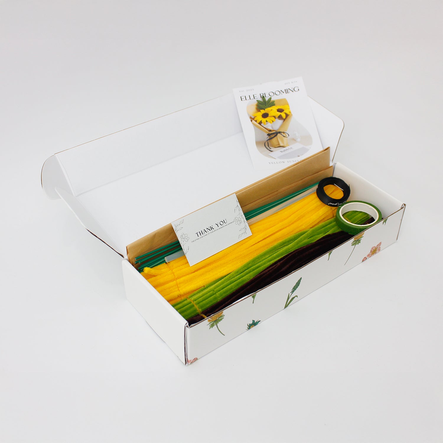 Yellow Sunflower DIY bouquet featuring two vibrant yellow pipe cleaner sunflowers with green leaves. Wrapped in kraft paper with black ribbon a handmade floral craft perfect for cheerful gifts and home décor.