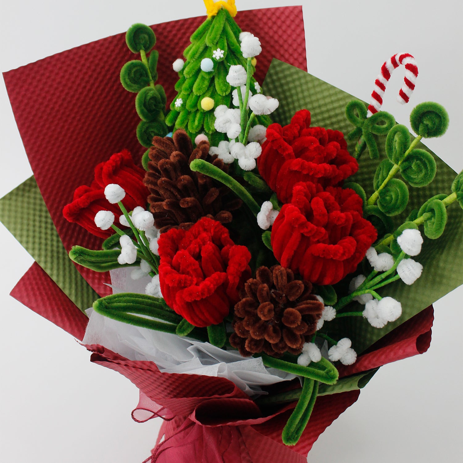 Midnight Evergreen DIY flower bouquet kit with red tulips, pinecones, white berries, candy cane, and a mini Christmas tree made from pipe cleaners. Ideal for holiday gifts or Christmas crafting fun.