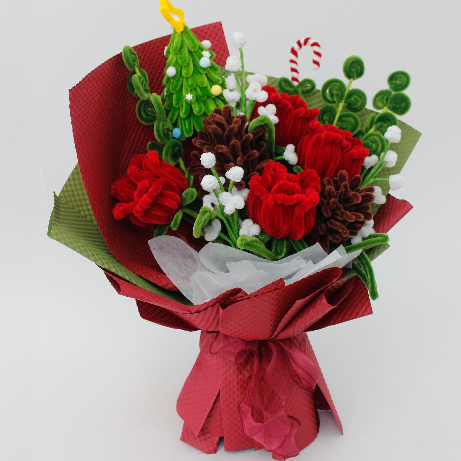Midnight Evergreen DIY flower bouquet kit with red tulips, pinecones, white berries, candy cane, and a mini Christmas tree made from pipe cleaners. Ideal for holiday gifts or Christmas crafting fun.