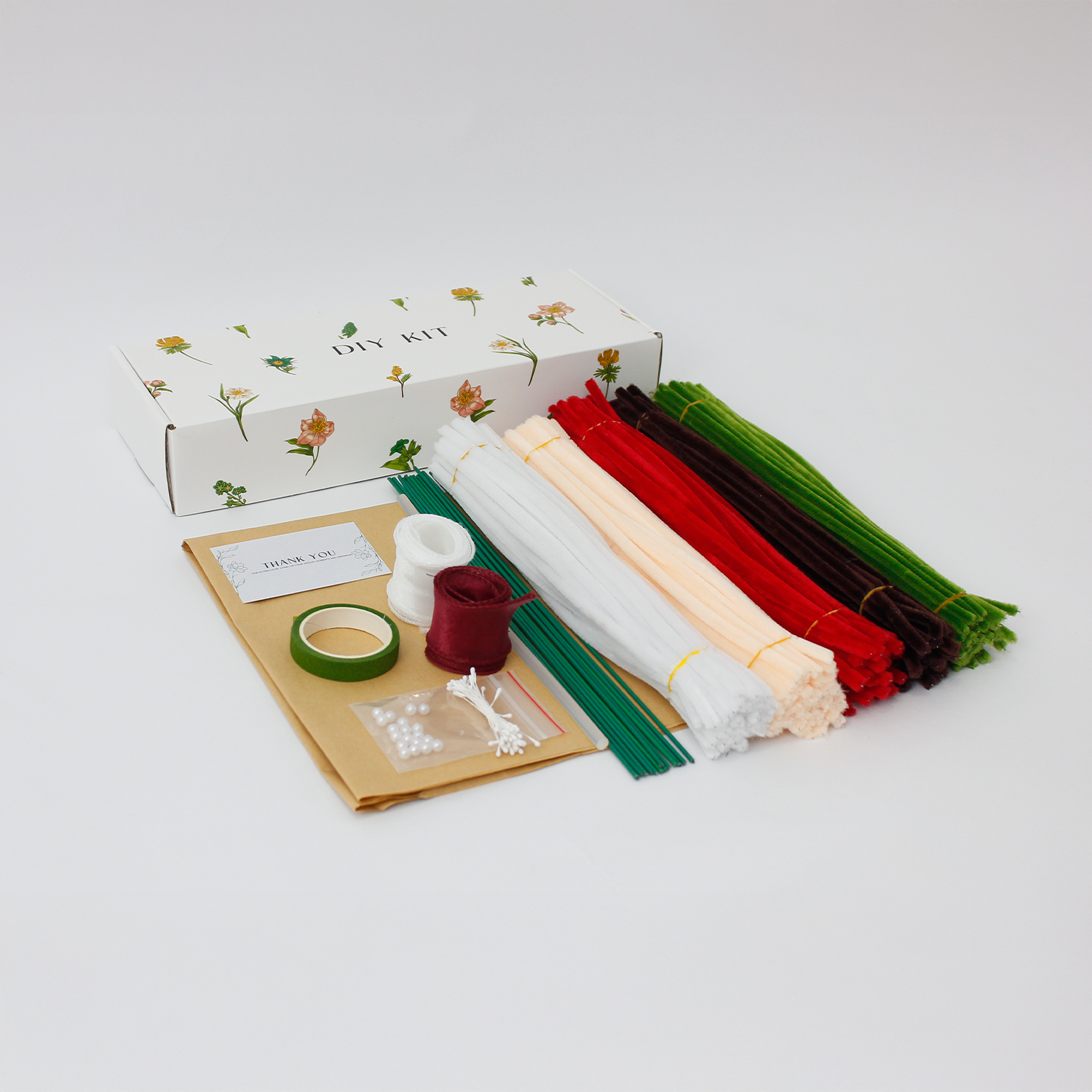 DIY flower bouquet kit "Winter Whispers" featuring handmade pinecones, red lily, candy cane, tulips, and cotton flowers made from pipe cleaners. Perfect for Christmas crafting or gifting.