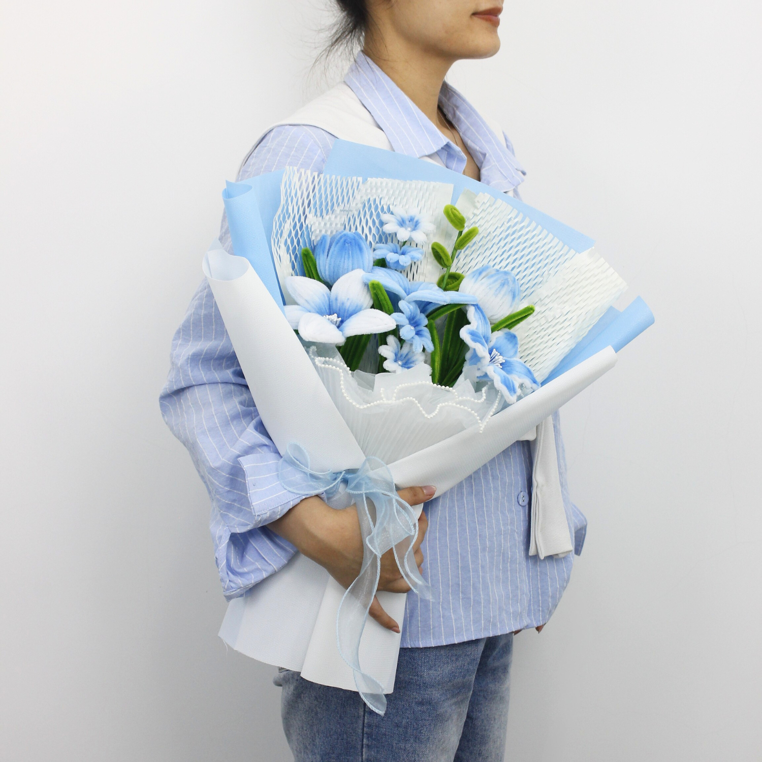 A handcrafted bouquet of baby blue cherish tiger lilies made from fuzzy pipe cleaners. Beautifully arranged and wrapped, perfect for gifting or elegant home decoration.