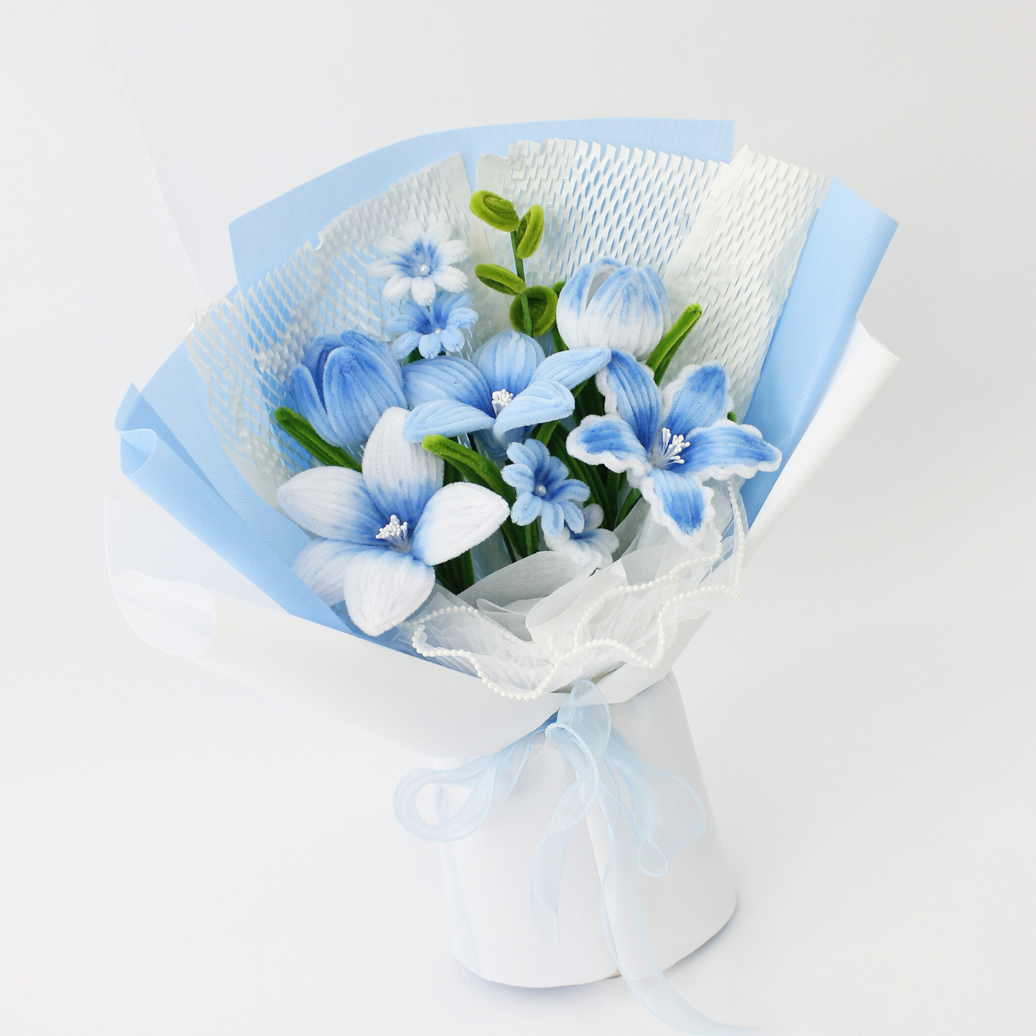 A handcrafted bouquet of baby blue cherish tiger lilies made from fuzzy pipe cleaners. Beautifully arranged and wrapped, perfect for gifting or elegant home decoration.
