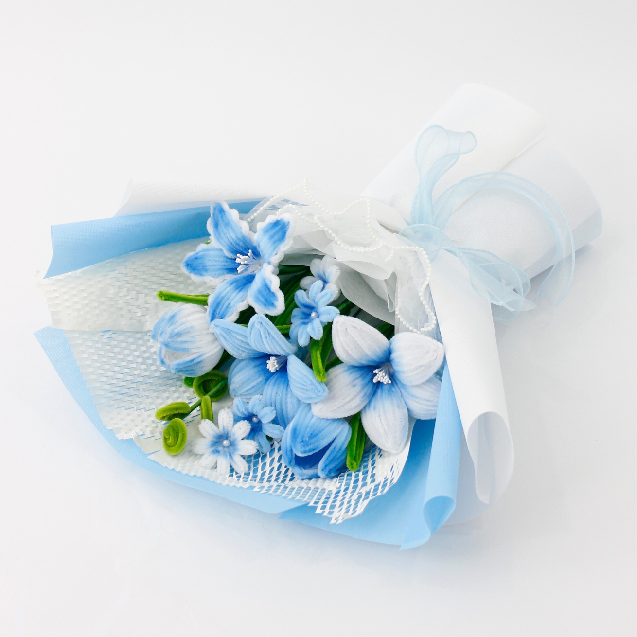 A handcrafted bouquet of baby blue cherish tiger lilies made from fuzzy pipe cleaners. Beautifully arranged and wrapped, perfect for gifting or elegant home decoration.