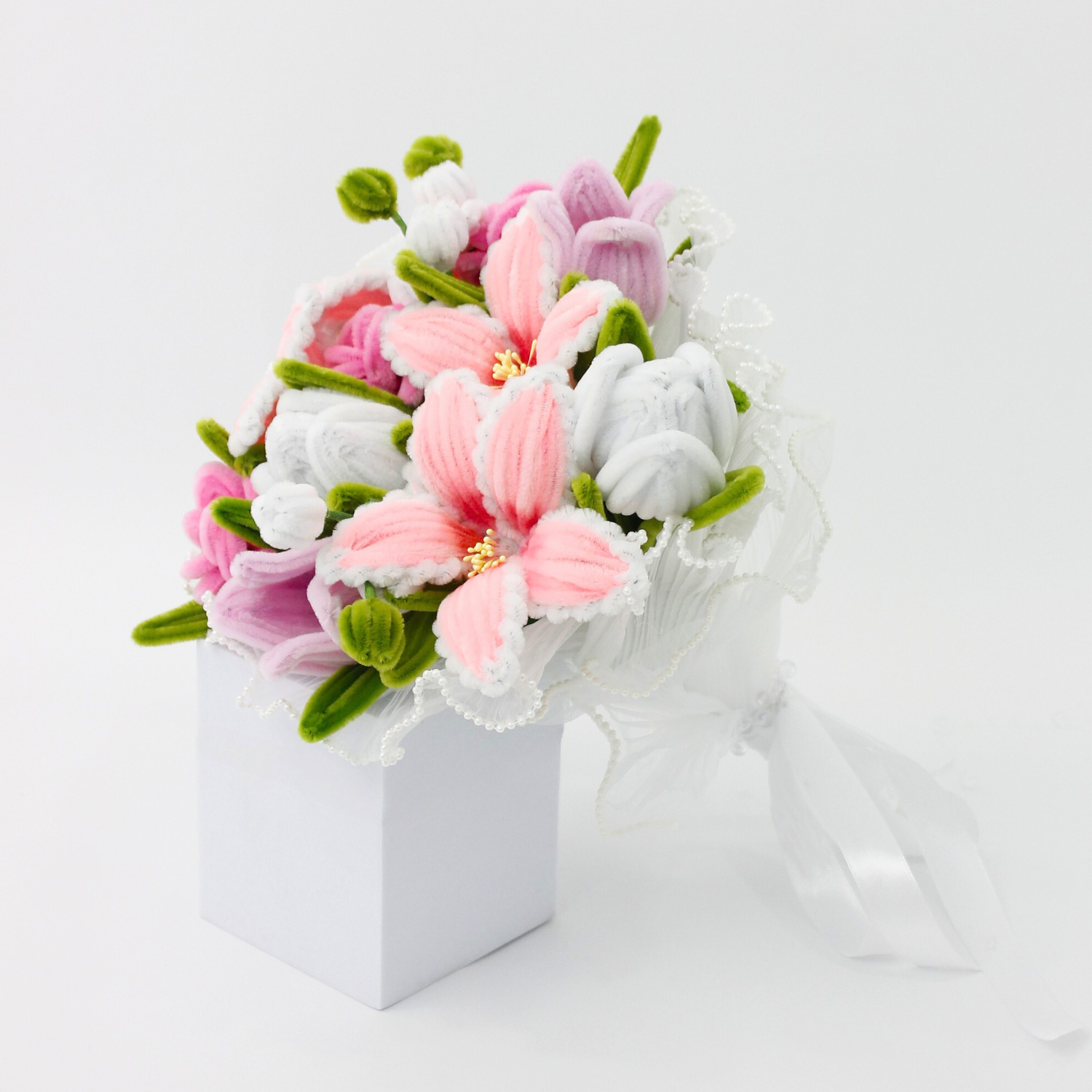 Bride holding a handmade everlasting wedding bouquet in pink and lilac tones with lilies and roses, crafted from pipe cleaners, romantic bridal flower arrangement in Australia.