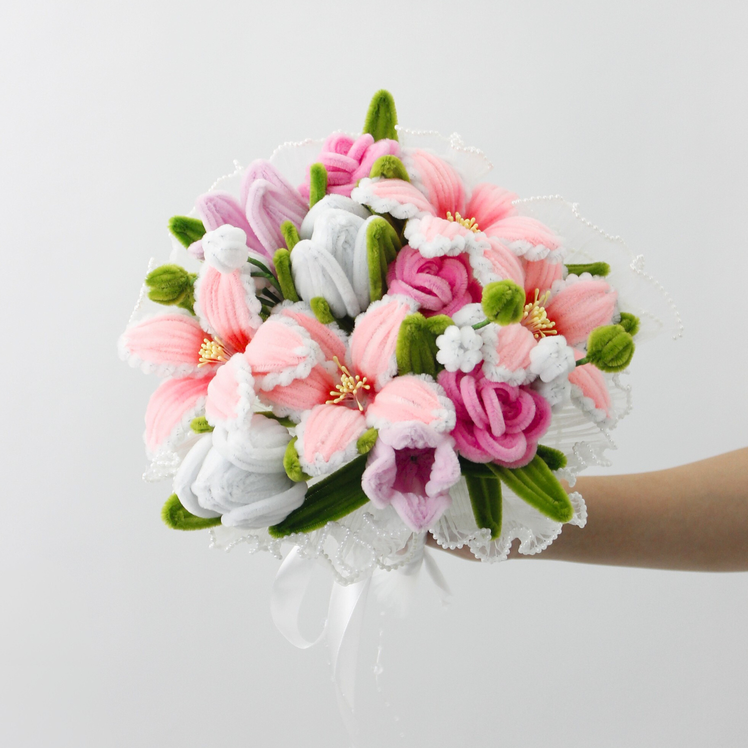 Bride holding a handmade everlasting wedding bouquet in pink and lilac tones with lilies and roses, crafted from pipe cleaners, romantic bridal flower arrangement in Australia.