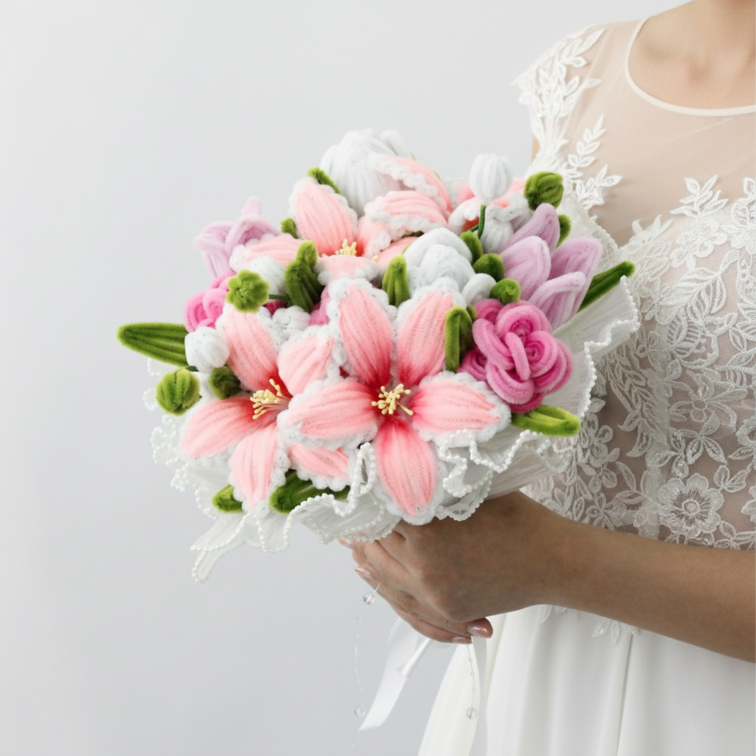 Bride holding a handmade everlasting wedding bouquet in pink and lilac tones with lilies and roses, crafted from pipe cleaners, romantic bridal flower arrangement in Australia.