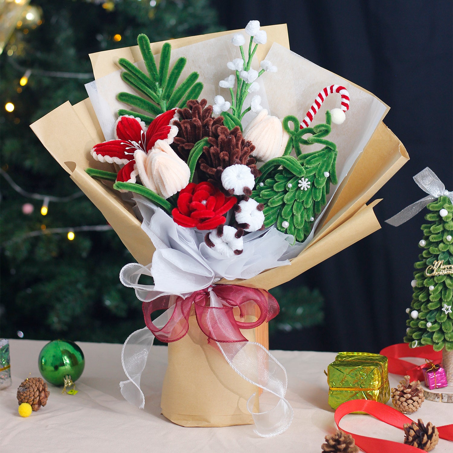 Handmade bouquet of white and blue pipe cleaner flowers wrapped in soft blue and white paper with ribbon. Features lifelike lilies and daisies. A winter-inspired, everlasting floral gift.