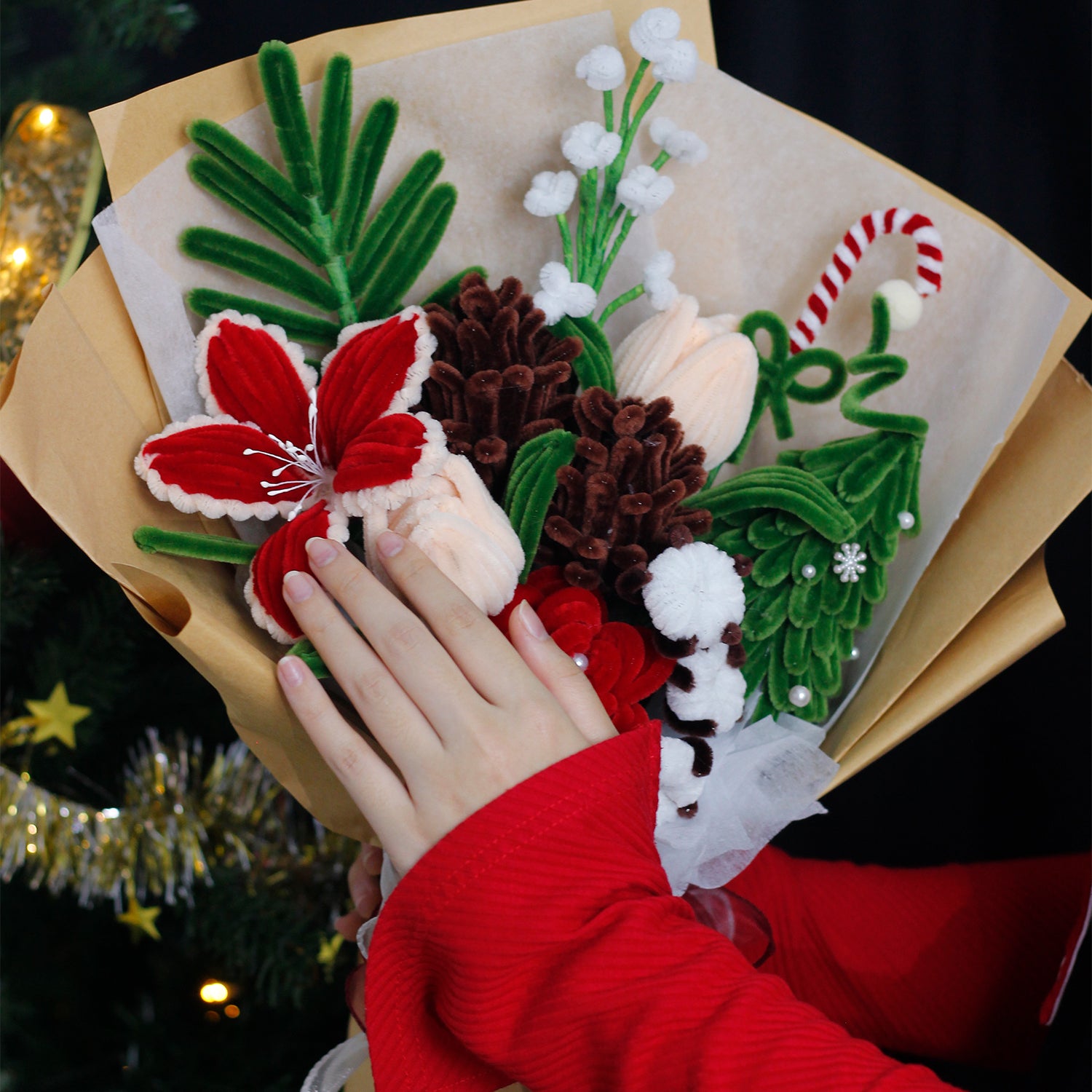 Handmade bouquet of white and blue pipe cleaner flowers wrapped in soft blue and white paper with ribbon. Features lifelike lilies and daisies. A winter-inspired, everlasting floral gift.