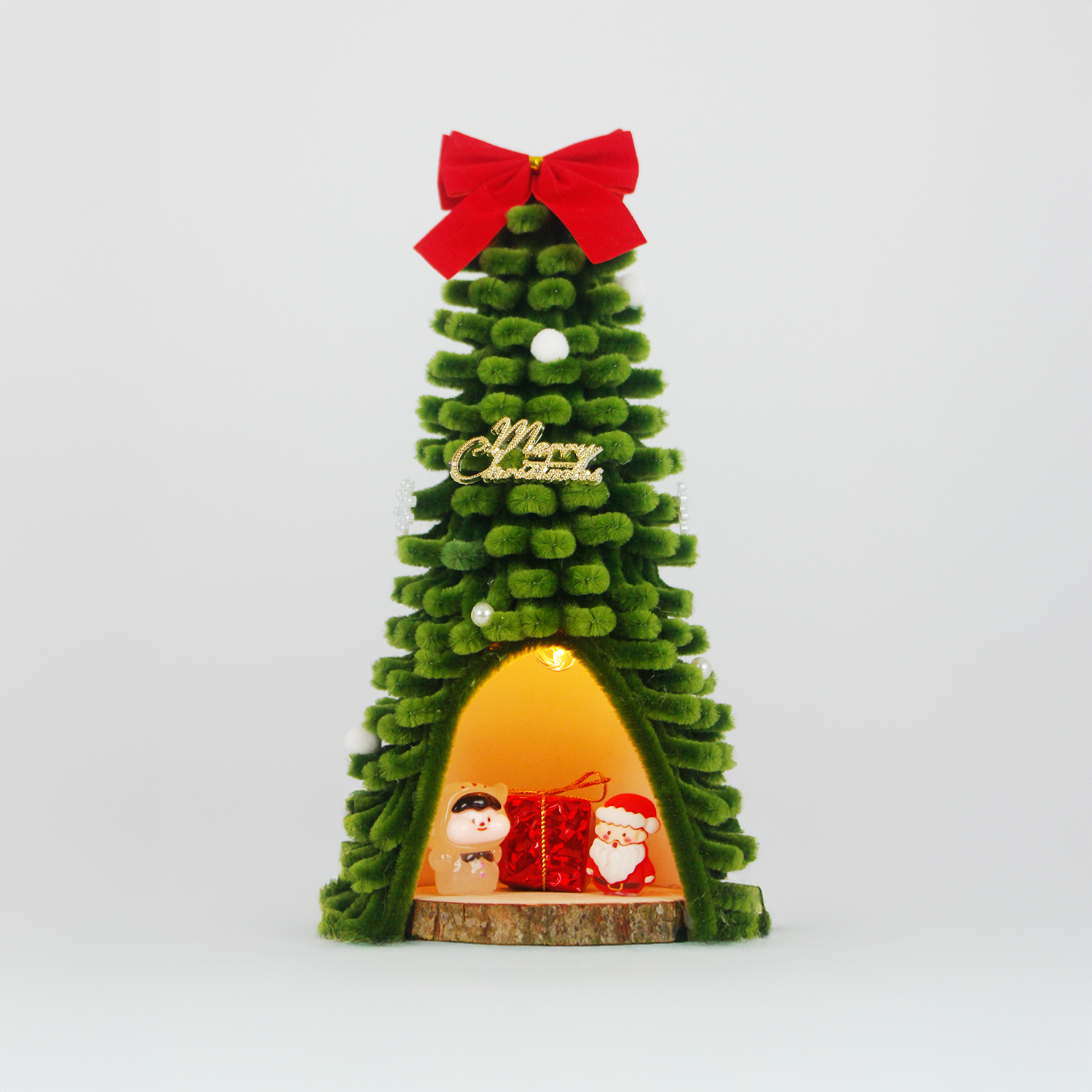 Green fuzzy wire Christmas tree featuring Santa Claus and pig figurine inside, topped with red bow – unique and charming holiday decor